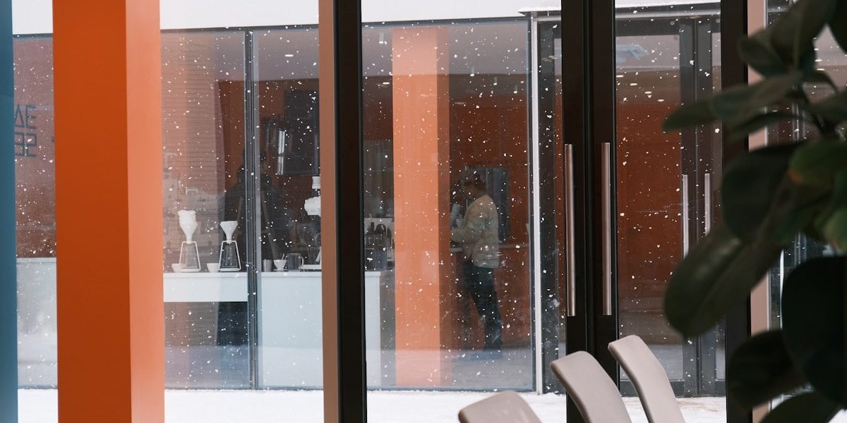 a room with a lot of chairs and a big window