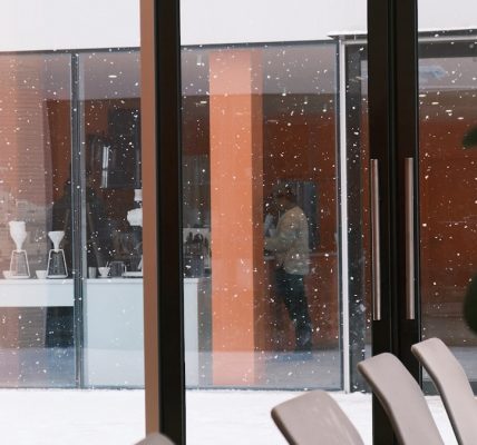 a room with a lot of chairs and a big window