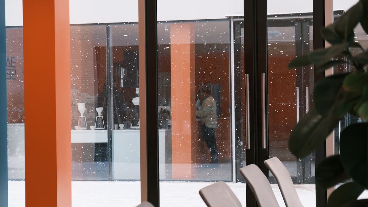 a room with a lot of chairs and a big window